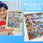 Aaron holding up a framed display case of butterflies painted with world flags on them