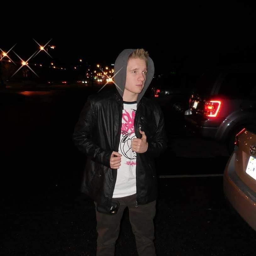 A young man in a black hoodie